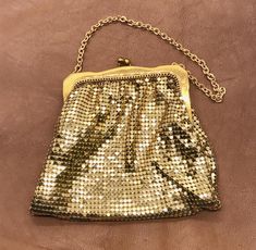 Sweet and glamorous, a little gold purse like this can be perfect when all you need is a lipstick and a bit of cash or plastic for your evening out.  It could even fit into a generously sized coat pocket. The chain mail is perfect and bright, the frame does have light marks from age, commiserate with prior use and storage.  It was very well cared for, though.  The interior is lining is spotless and the original tag is still in place.  This will be shipped in a box.  This gorgeous little bag meas Cheap Vintage Gold Bags, Vintage Gold Shopping Bags, Vintage Gold Bag With Chain, Vintage Gold Handcrafted Bag, Coat Pocket, Gold Bag, Evening Purse, Chain Mail