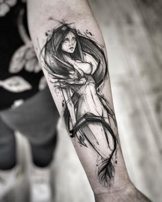 a woman's arm with a black and white tattoo design on the left forearm