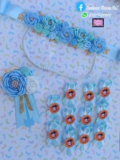 some blue flowers and ribbons on a white table with other items in the background that include broochies