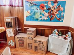 several cardboard boxes are stacked on top of each other in front of a wall mural