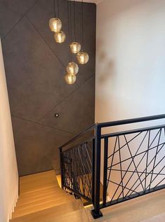 a staircase with lights hanging from the ceiling