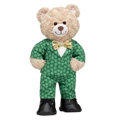 a teddy bear dressed in green and black with a bow tie on it's chest