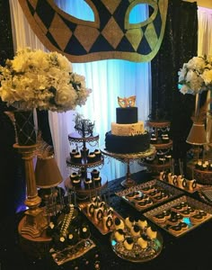 a table topped with lots of cakes and cupcakes