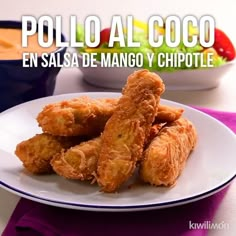 fried food on a white plate with the words polo al coco en salsa de mango y chipotle