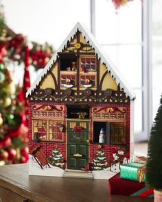 a christmas scene with a gingerbread house and presents