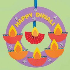 a circular ornament with candles and stars on it that says happy diwal