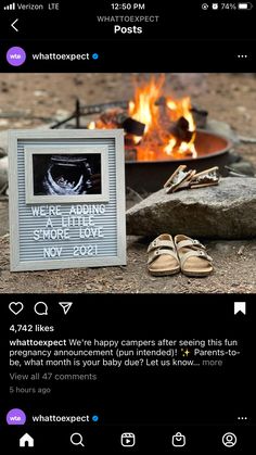 a photo frame sitting next to a campfire with shoes on the ground in front of it