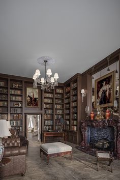 a living room filled with furniture and bookshelves covered in lots of bookcases