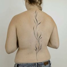 the back of a woman's body with tattoos on her upper and lower back