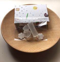 two pieces of cake sitting on top of a wooden plate next to a package with white frosting