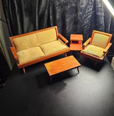 three pieces of furniture sitting on top of a black surface