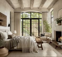 a bedroom with a fireplace and large windows