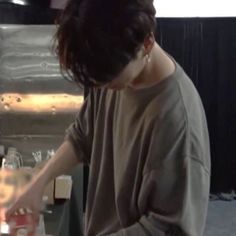 a person standing in front of a counter preparing food