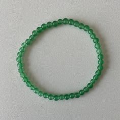 The Green Aventurine Bead Bracelet is a beautiful and uplifting piece known for its association with luck and prosperity. Green Aventurine is often called the "Stone of Opportunity," believed to attract good fortune and encourage positive outcomes in life. Its soothing green hue makes it a perfect accessory for those seeking both style and metaphysical benefits. Wear this bracelet to enhance your confidence and manifest opportunities, or gift it to someone who could use a little extra luck. Meta Cheap Green Beaded Braided Bracelets, Manifest Opportunities, Incense Oil, Oil Candles, Good Fortune, Green Aventurine, Tarot Decks, Bead Bracelet, Beaded Bracelet