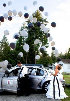 a couple getting into their wedding car with paper lanterns in the air and plates on the ground