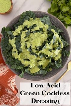 a bowl filled with green goddess dressing on top of a table