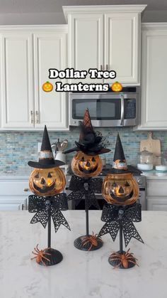 three pumpkins are sitting on top of each other in front of the kitchen counter