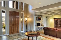 a living room filled with furniture and a chess board on top of a coffee table