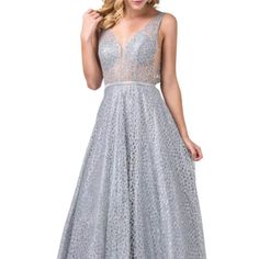 Tailored In A Glitter Mesh Fabric, This Full-Length Gown Captivates In Sleeveless Sheer Illusion Bodice With Mesh Centered Deep V Neckline. This Ensemble Comes With Illusion Side Cutouts And A Flattering V Back. The Natural Waist Is Ornate With Rhinestone Band Leading To The Full-Length A Line, Multi-Layered Skirt. The Model Is Wearing Silver Color. The Available Color Is Silver. Fabric: 100% Polyester, Glitter Mesh Origin: Made In The Usa Or Imported Occasion: Ball, Prom And Any Special Event. Dancing Queen Dresses, Full Length Gowns, Dress Silver, Silver Fabric, Beaded Belt, Dancing Queen, Layered Skirt, Silver Dress, Dress Picture