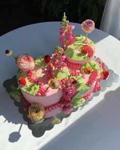 a cake decorated with flowers on top of a table