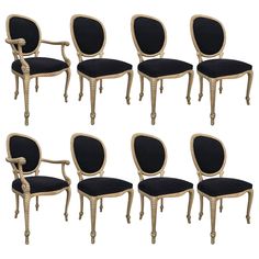 six chairs with black velvet upholstered back and arms, all in different styles