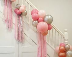 balloons and streamers are hanging from the banisters on this staircase for a party