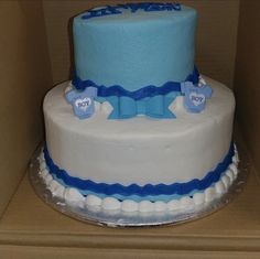 a blue and white cake sitting on top of a cardboard box