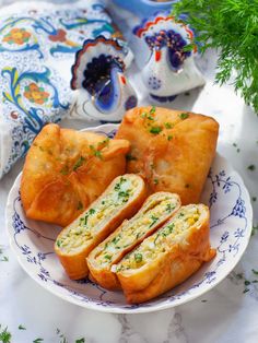 two pieces of bread on a blue and white plate with parsley sprigs