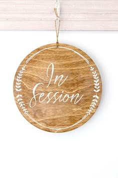 a wooden ornament with the words i'm session on it hanging from a door