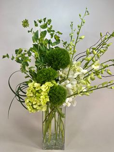 a vase filled with green and white flowers