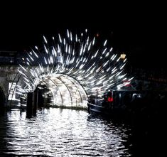 fireworks are lit up in the night sky over water