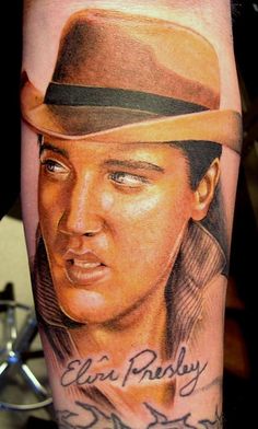 a man's arm with an elvis presley tattoo on it