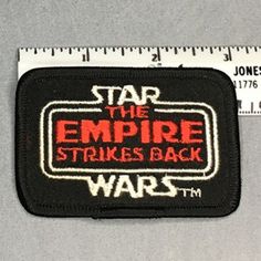 star the empire strikes back wars iron - on patch with measuring tape in front of it