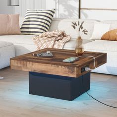 a coffee table sitting on top of a hard wood floor next to a white couch