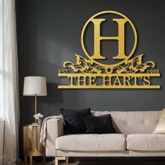 a living room filled with furniture and a large metal wall sign that reads the harts