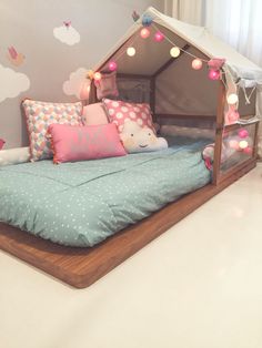 a child's bed made out of a tent and pillows