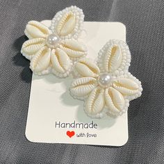 Beautiful Cowry shell stud earrings . Perfect to wear on vacations or beach.  Best thing is that it can be worn for long hours as it is lightweight. 100% Handmade Closure- pushback Back of the earring is white leather. Each piece is handmade with love.  Free shipping to Canada and USA. It will be shipped via regular non trackable Canada post parcel within 2 days after placing the order. Estimate shipping times for Canada is 4-6 days. USA- 1-2 weeks. Thankyou for checking out my shop! If you have White Shell-shaped Earrings For Vacation, Handmade White Beachy Earrings, White Beaded Earrings For Summer Beach, Coastal Shell For Summer, White Beaded Earrings For Summer, White Beaded Earrings For Beach Summer, White Beaded Earrings For Beach And Summer, Coastal Style Shell For Summer, White Beaded Shell For Beach Season