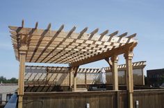 a wooden pergoline on top of a roof