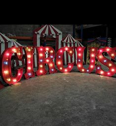 the word circus is lit up in red and white lights