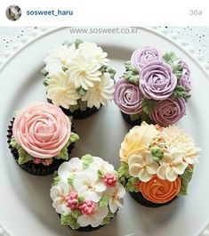 cupcakes decorated with flowers on a plate