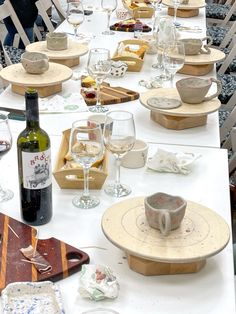 a long table is set with wine glasses and plates