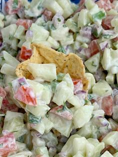 a bowl filled with potato salad and a tortilla chip