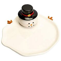 a white tray with a black lid and a snowman design on the bottom, sitting on top of it