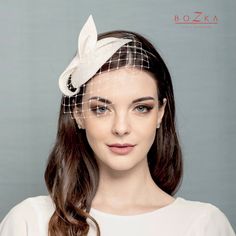 a woman wearing a white veil with a flower on it's head and long hair