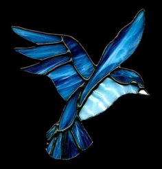 a stained glass bird flying in the air