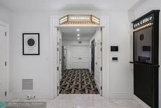 an entry way leading into a home with white walls and black trim on the doors