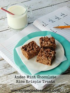 three pieces of chocolate rice krispie treats on a plate next to a glass of milk