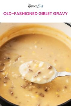 a ladle full of old - fashioned gliet gravy in a pot