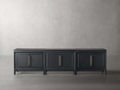 a black sideboard with three doors and two drawers