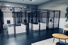 a living room filled with lots of caged in furniture next to a wall mounted tv